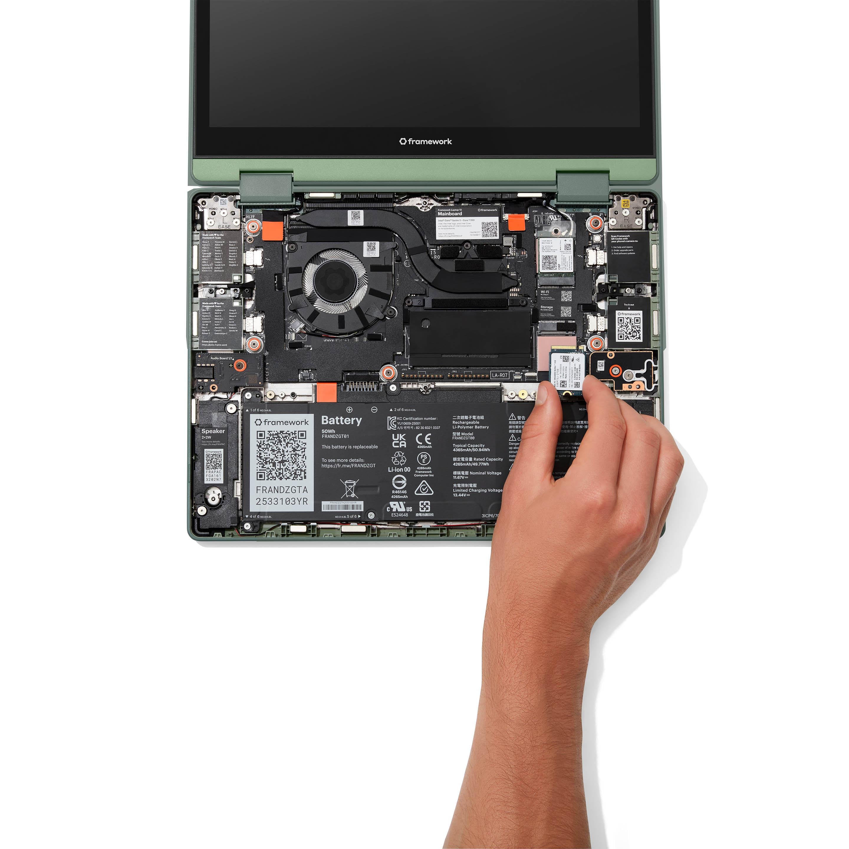Image of hand installing storage into a Framework Laptop 12